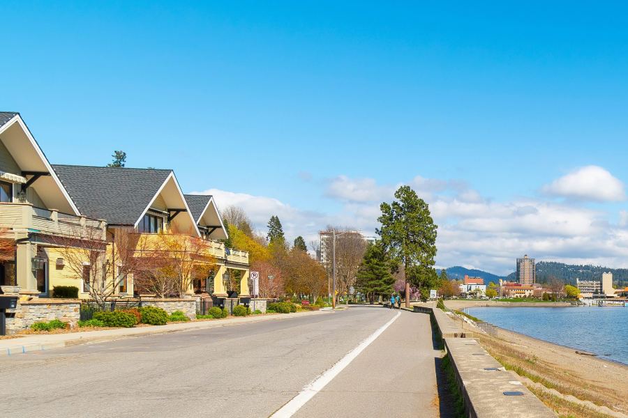 Homes beside a lake with wooded hills across the water